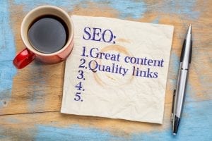 Napkin and coffee cup with SEO written in napkin