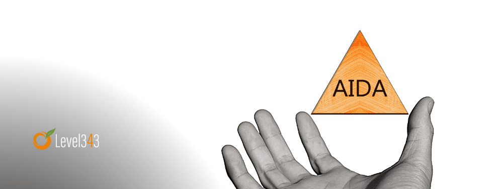 Hand holding AIDA triangle