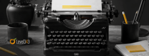 Black-and-white typewriter on a writer’s desk with yellow accents on the paper, pencil, sticky note, and lamp shade.