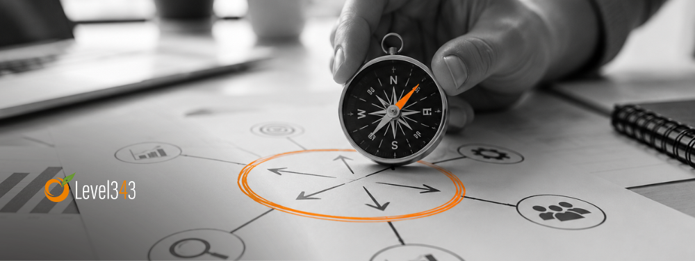 A hand uses a compass to find direction on a strategy diagram, with an orange circle highlighting the central decision point.