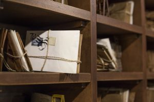 stack of direct mail marketing on an old shelf