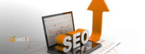 SEO sign sitting on a laptop with an arrow pointing up to indicate better ranking