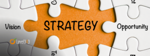 marketing strategies concept: "strategy" written in the space of a puzzle piece, with business terms written on other puzzle pieces