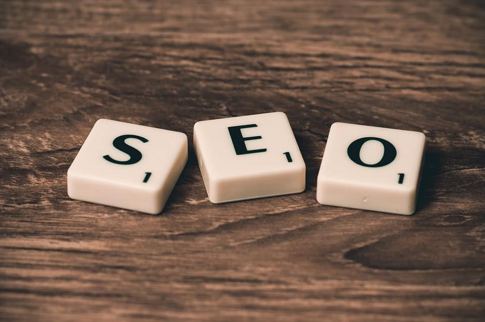 small white cubes with black letters that spell our SEO.