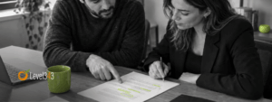 Two colleagues review suggested edits to a service-page draft.