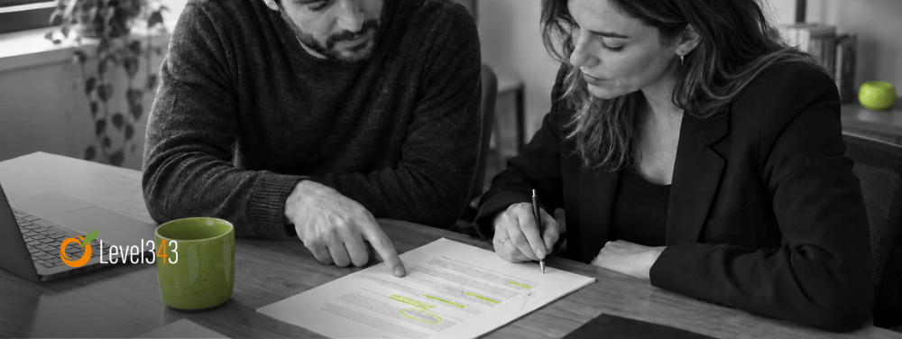 Two colleagues review suggested edits to a service-page draft.