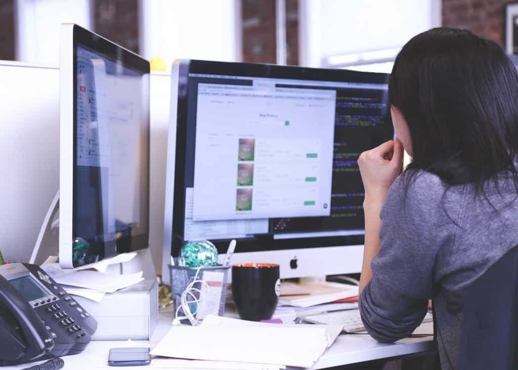 Woman facing Computer monitor