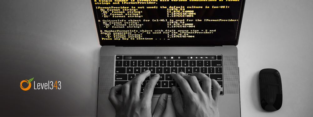 Hands typing code on a computer