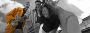 Group of individuals looking at a cell phone and laughing