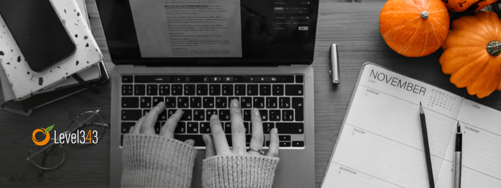 person creates a blog post on a laptop at a table
